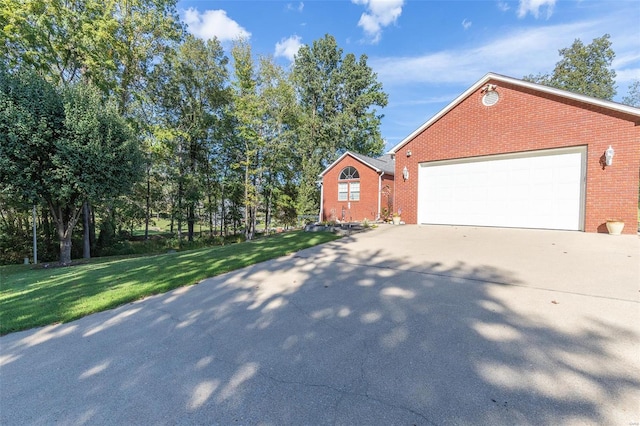 view of side of home with a yard and a garage