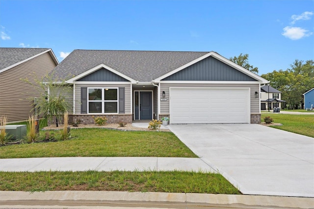 craftsman-style house featuring a front yard, a garage, and central AC