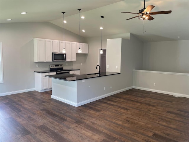 kitchen with white cabinetry, appliances with stainless steel finishes, decorative light fixtures, and vaulted ceiling