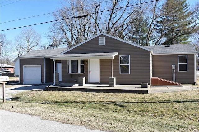 ranch-style house with covered porch, a front yard, and a garage