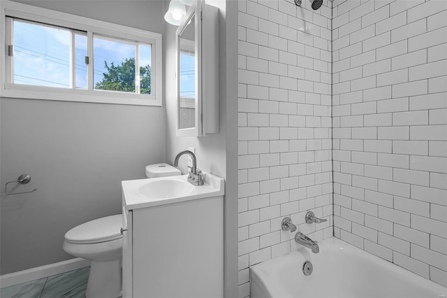 full bathroom featuring tiled shower / bath, vanity, and toilet