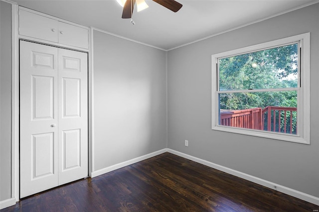 unfurnished bedroom featuring ornamental molding, a closet, ceiling fan, and dark hardwood / wood-style floors