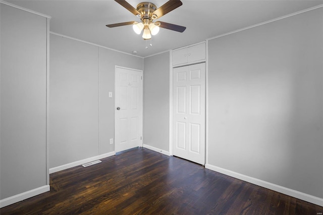 unfurnished bedroom featuring crown molding, dark hardwood / wood-style floors, and ceiling fan