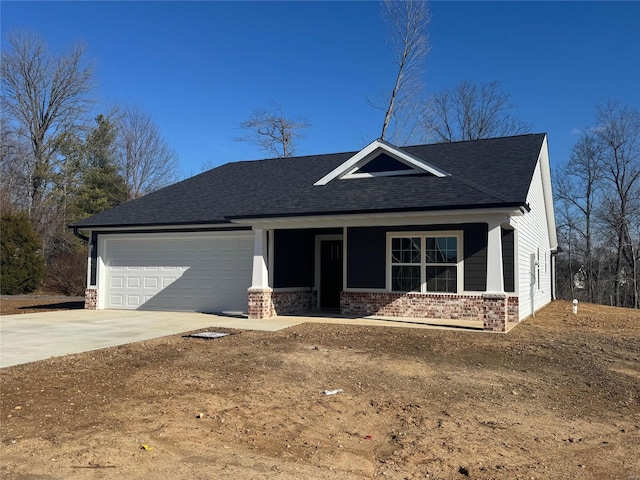 view of front of home with a porch and a garage