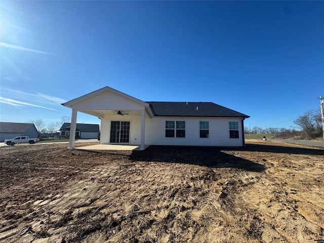 rear view of property with ceiling fan and a patio area