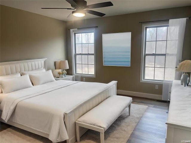 bedroom with wood-type flooring and ceiling fan