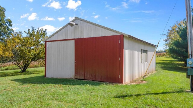 view of outbuilding featuring a lawn