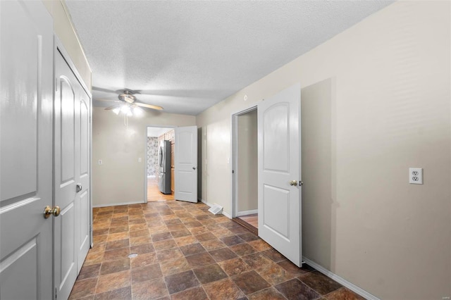 corridor with a textured ceiling