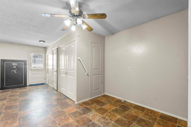 interior space featuring ceiling fan and a textured ceiling