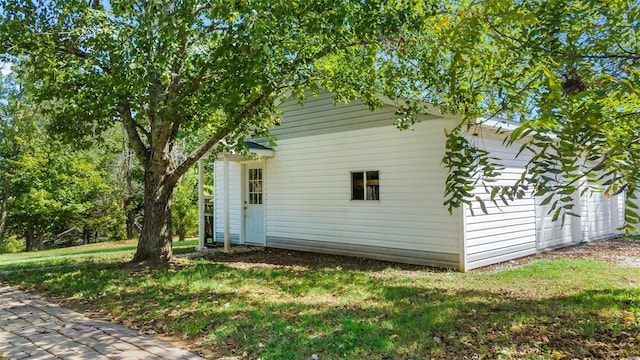 view of side of home with a lawn