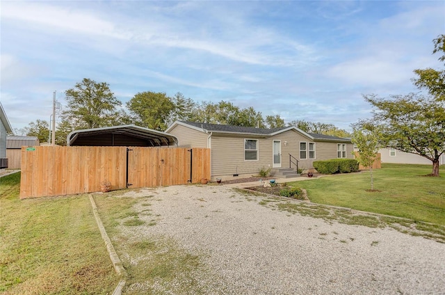 view of front of house with a carport and a front lawn