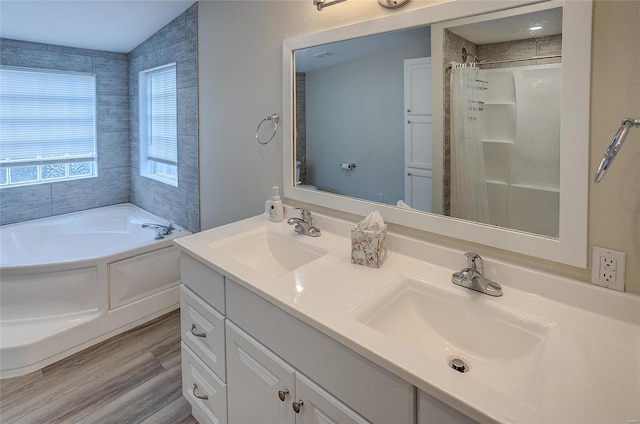 bathroom featuring vanity, hardwood / wood-style floors, vaulted ceiling, and separate shower and tub