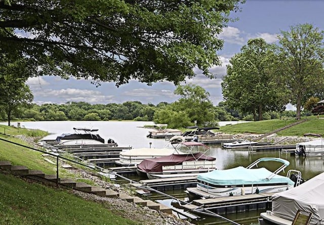 dock area featuring a lawn and a water view