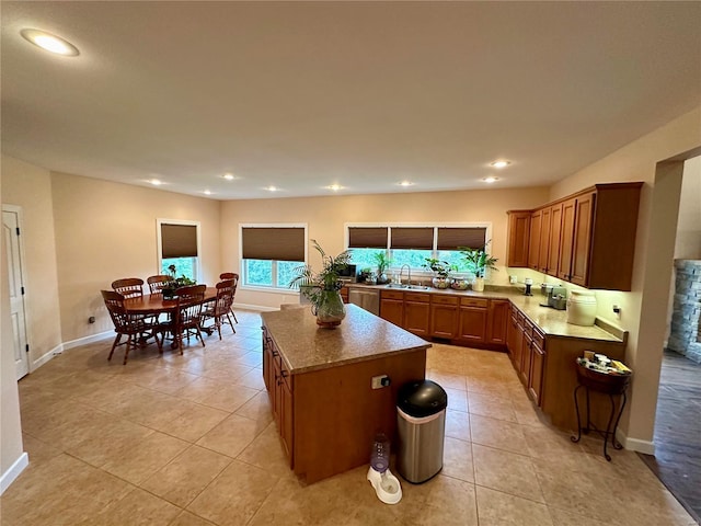 kitchen featuring a center island, light tile patterned floors, and sink