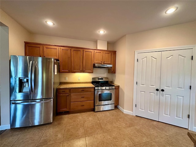 kitchen with appliances with stainless steel finishes and light tile patterned flooring