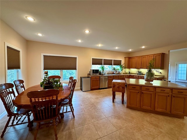 tiled dining room featuring sink