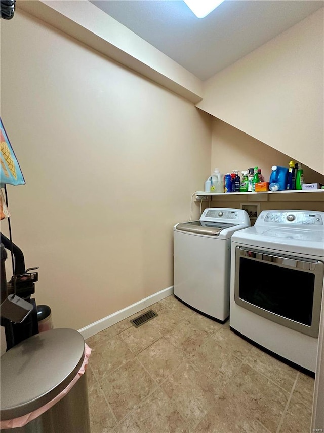 clothes washing area with washer and dryer