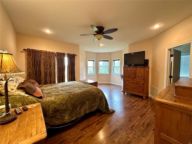 bedroom with ceiling fan and dark hardwood / wood-style flooring