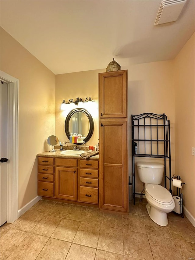 bathroom featuring tile patterned floors, vanity, and toilet