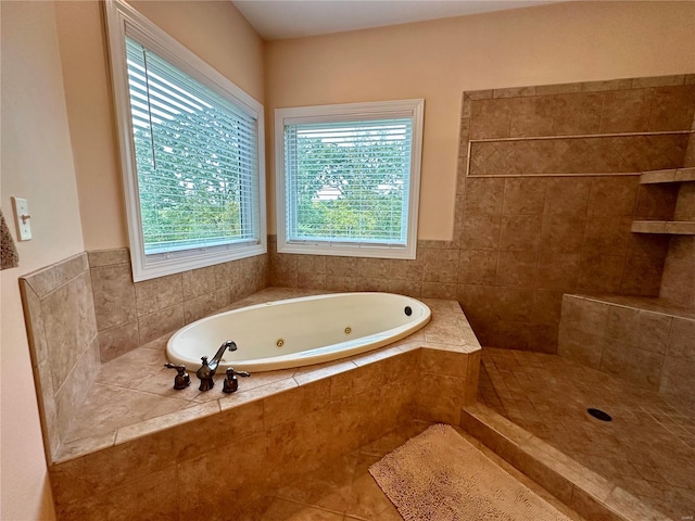 bathroom featuring tiled tub and tile patterned floors