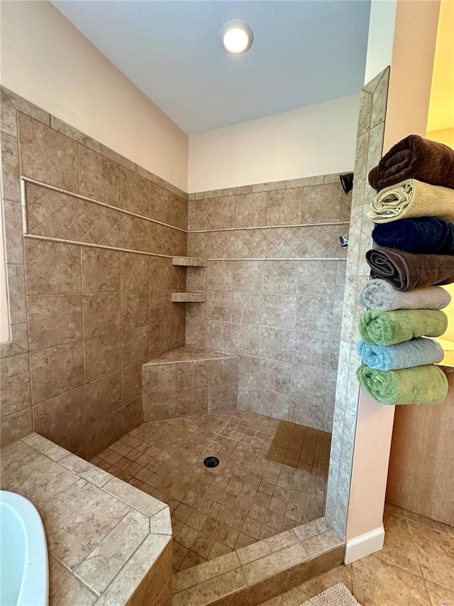 bathroom featuring tile patterned flooring and tiled shower