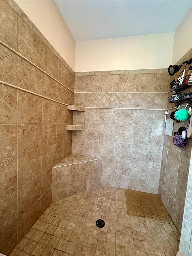 bathroom with a tile shower