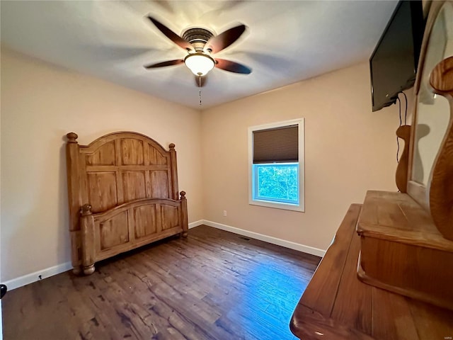 bedroom featuring ceiling fan and dark hardwood / wood-style floors