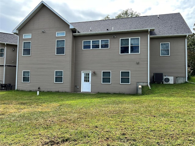 rear view of property with a lawn