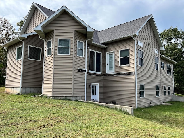 rear view of property with a yard