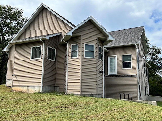 rear view of house with a yard