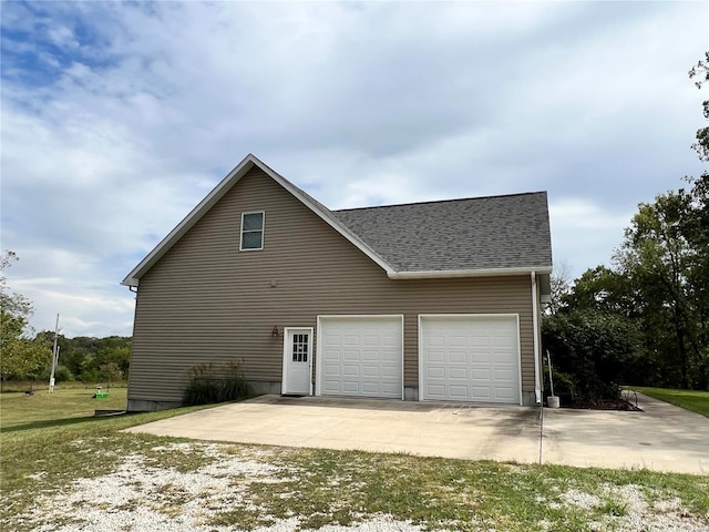 view of home's exterior with a garage and a lawn