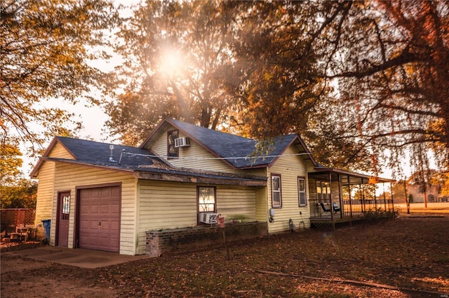 view of property exterior with cooling unit and a garage