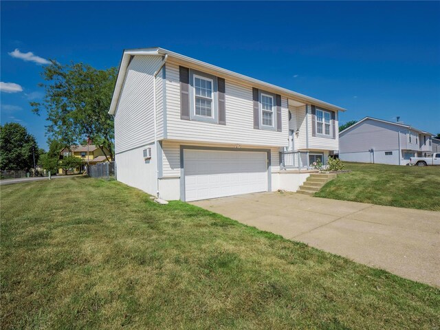 raised ranch with a garage and a front yard