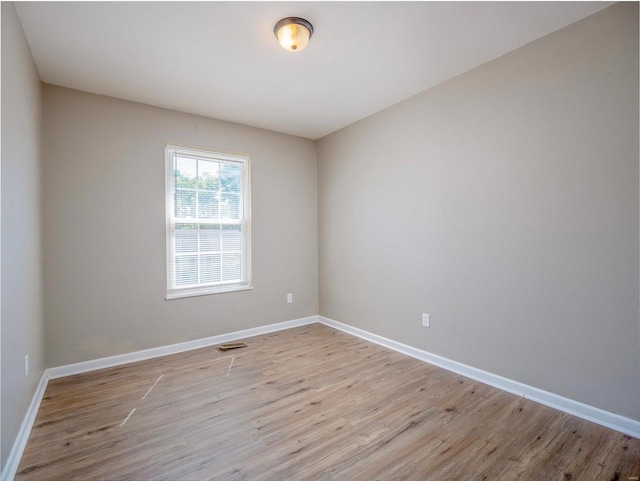 spare room featuring light hardwood / wood-style flooring