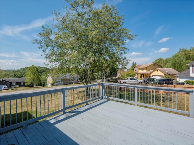 wooden deck featuring a lawn