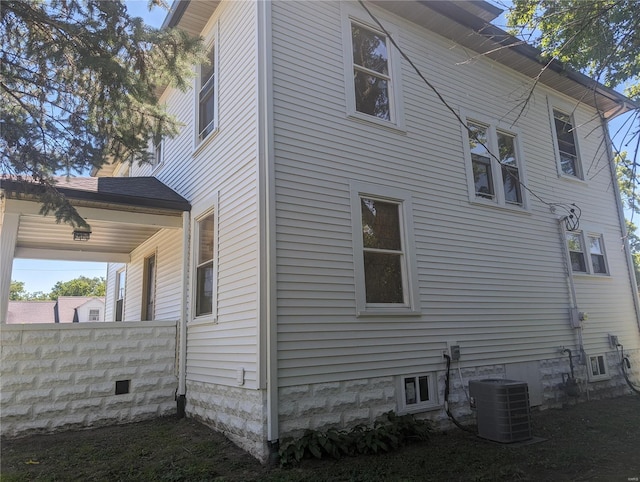 view of side of property featuring central air condition unit