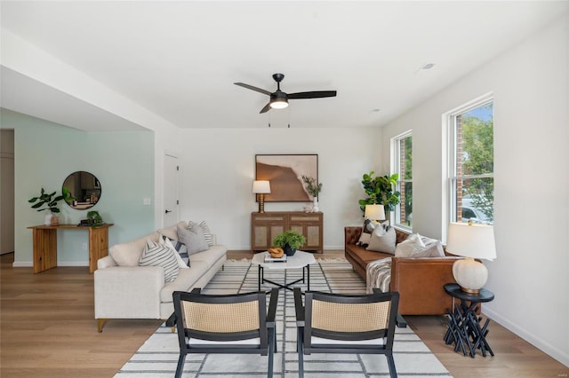 living room featuring light hardwood / wood-style flooring and ceiling fan