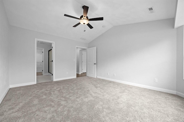 unfurnished bedroom featuring connected bathroom, lofted ceiling, carpet flooring, and ceiling fan