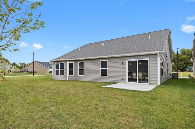 back of house featuring central AC, a patio area, and a yard