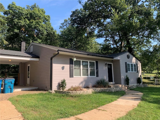 ranch-style home with a front yard and a carport