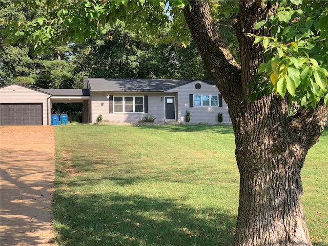 single story home with a front yard and a garage