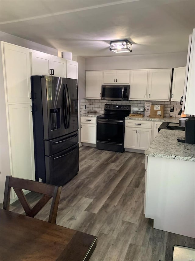 kitchen with stainless steel appliances, dark hardwood / wood-style floors, decorative backsplash, and white cabinetry