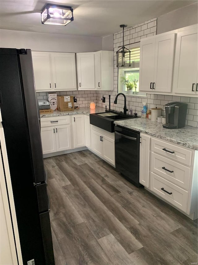 kitchen featuring stainless steel refrigerator, white cabinetry, and dishwasher