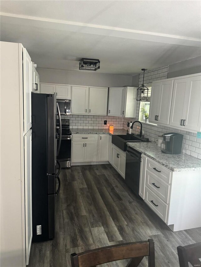 kitchen with decorative backsplash, stainless steel appliances, white cabinetry, and sink