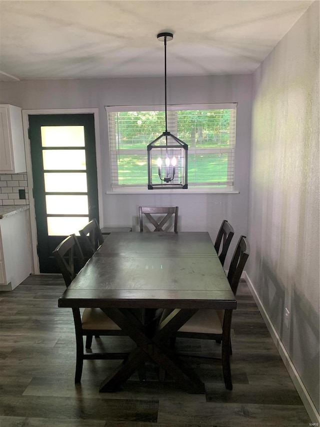 dining room featuring an inviting chandelier and dark hardwood / wood-style floors