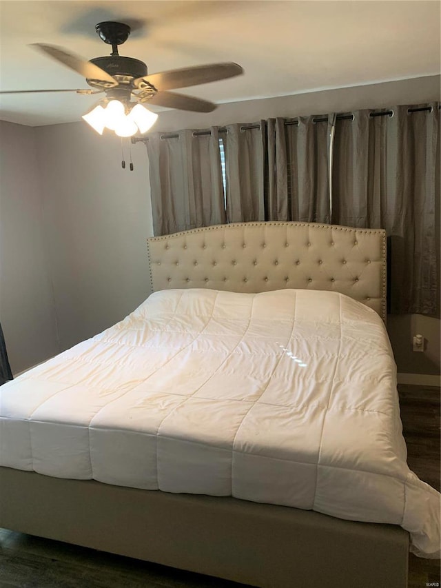 bedroom with ceiling fan and dark hardwood / wood-style flooring