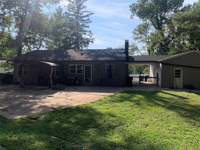 rear view of property with a patio and a yard