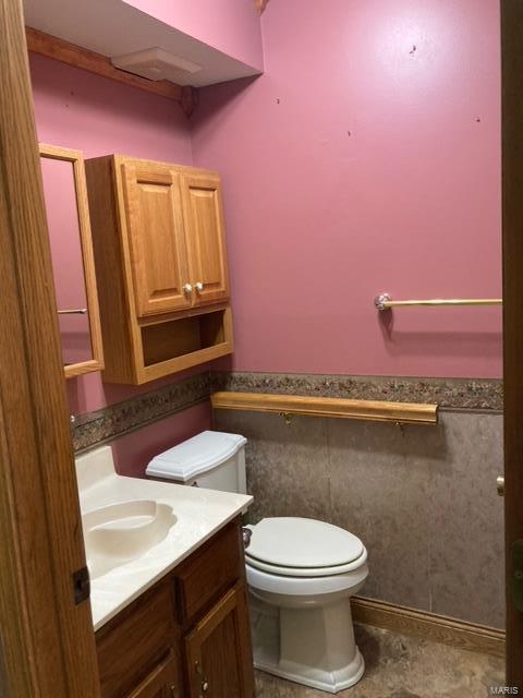 bathroom featuring vanity and toilet