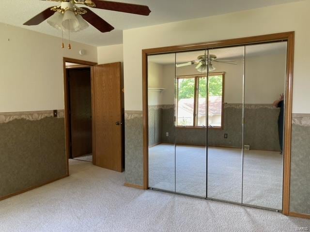 unfurnished bedroom featuring carpet flooring and ceiling fan