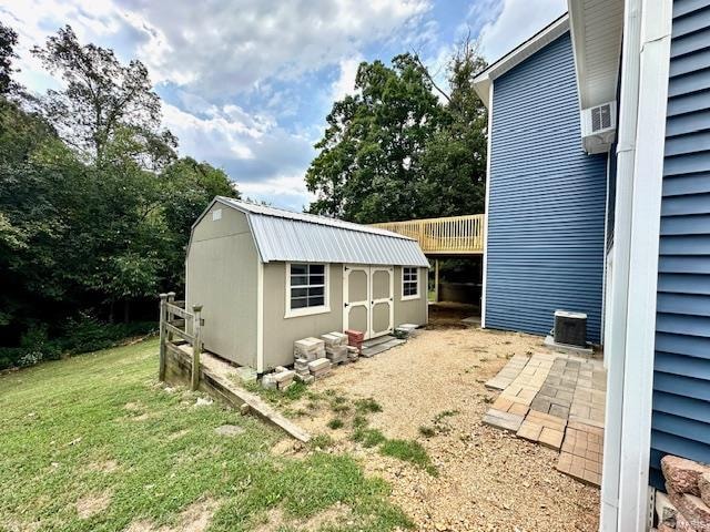 view of outbuilding with a yard and central AC